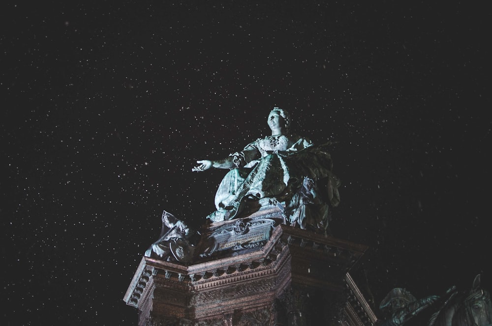 estatua gris bajo el cielo nocturno