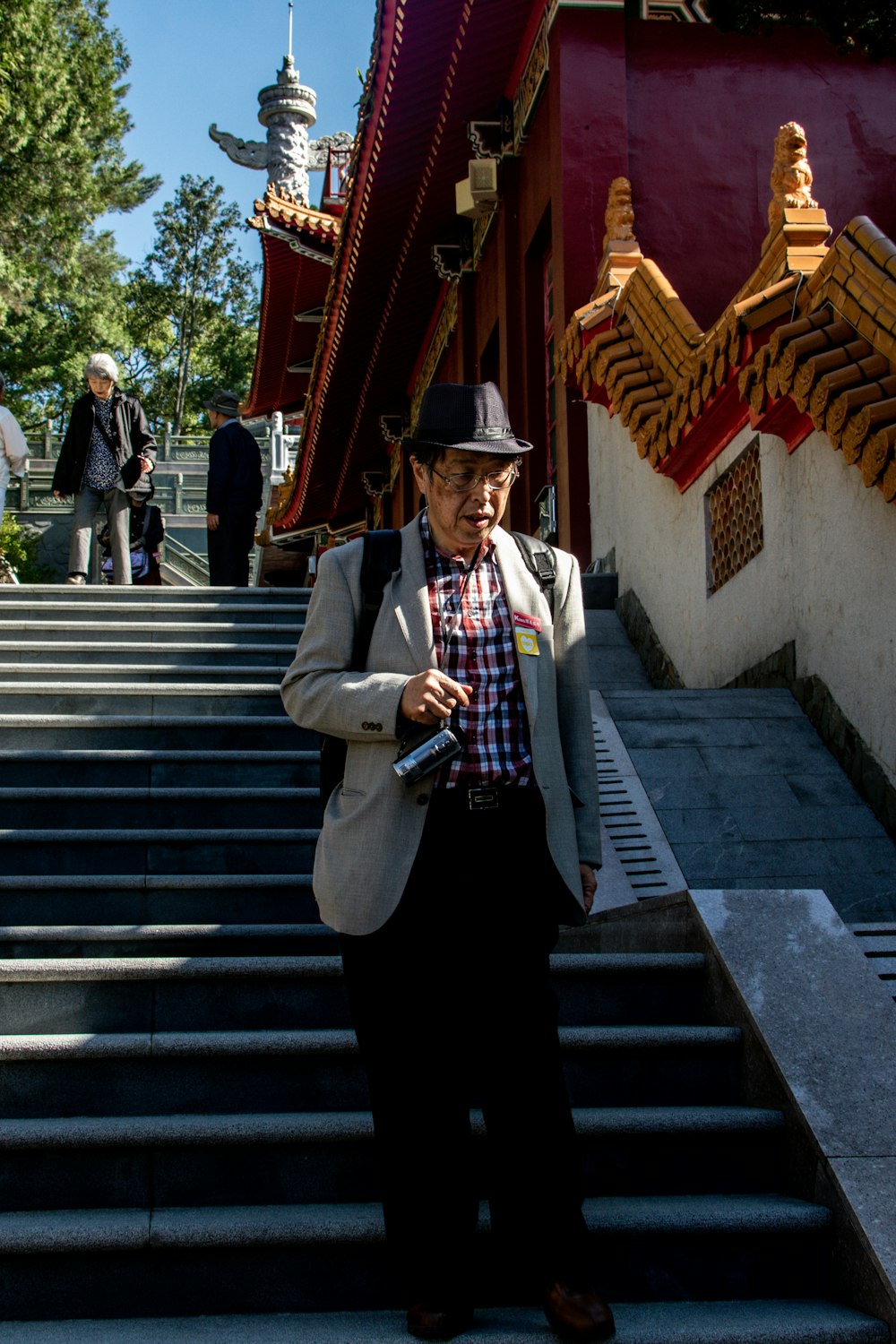 man in gray suit jacket walking down on stairs