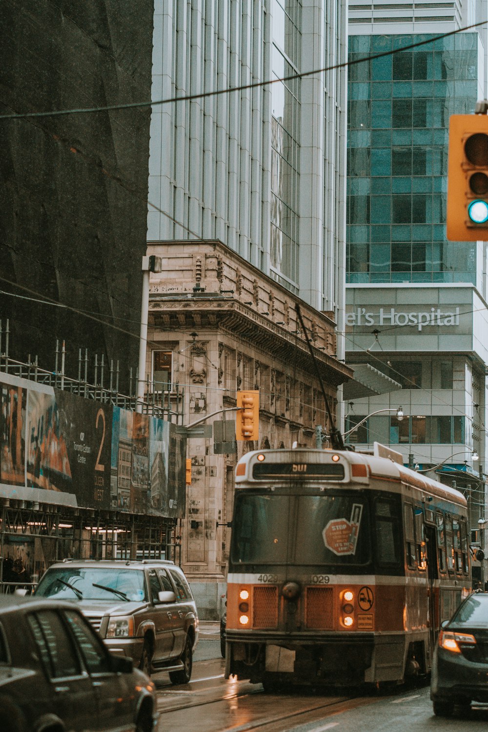 brown commuter bus on road near buildings during daytime