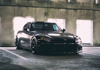 black Honda coupe parked inside building