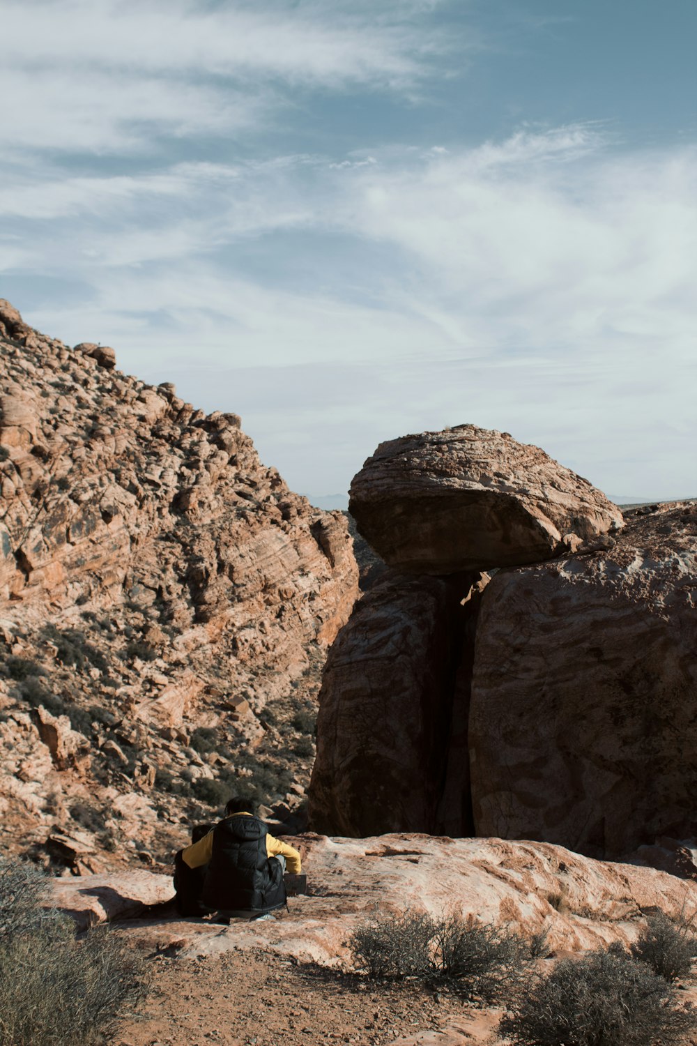 person sitting on rock