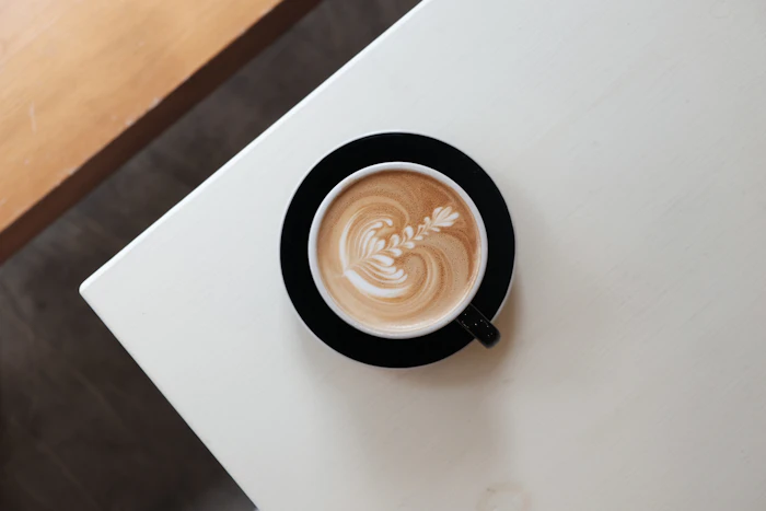 Coffee cup with latte art on a white table