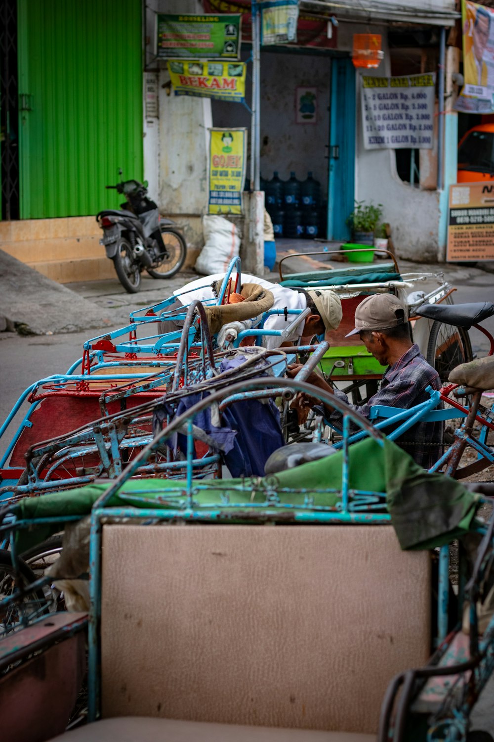 man sitting on pedal trike near buildings