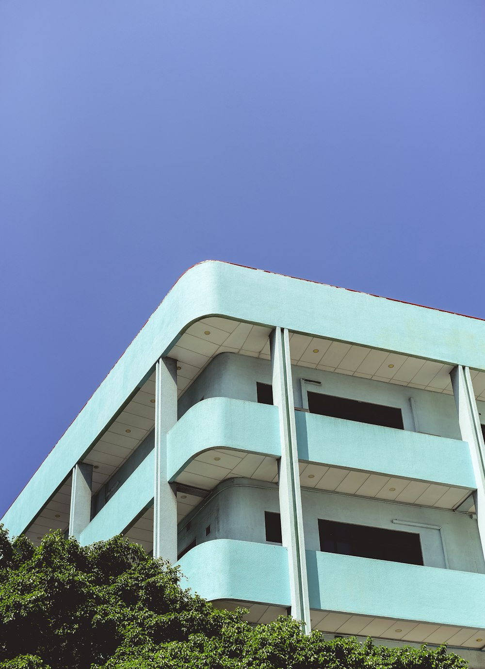 low angle photography of teal building