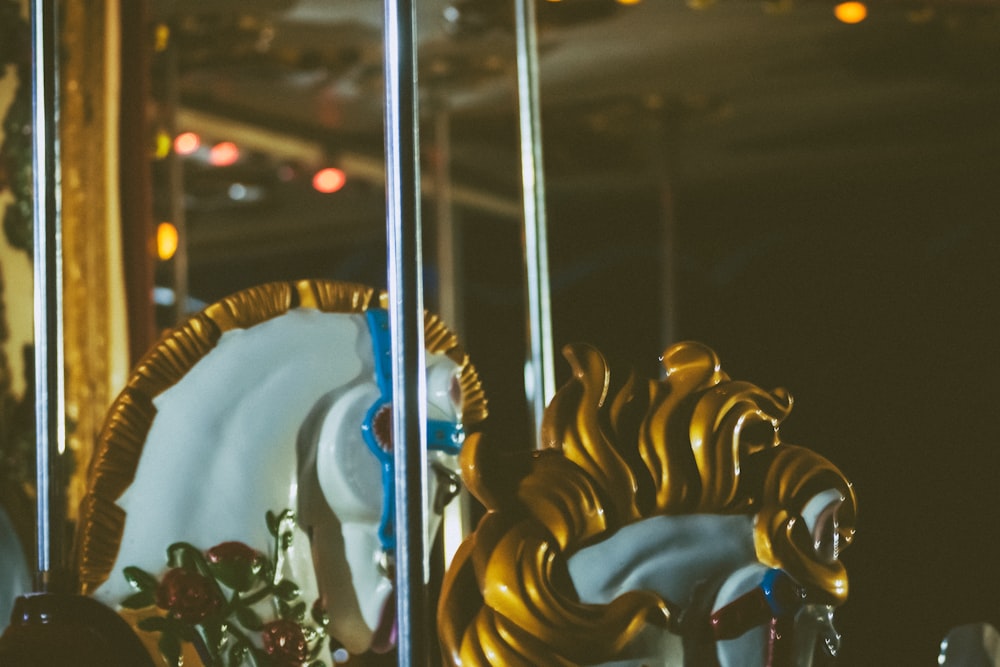 white and brown horse carousel ride during night