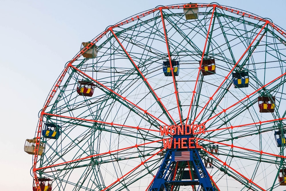 red and blue ferris wheels during daytime