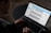 A person using a laptop with various online tools displayed on the screen.
