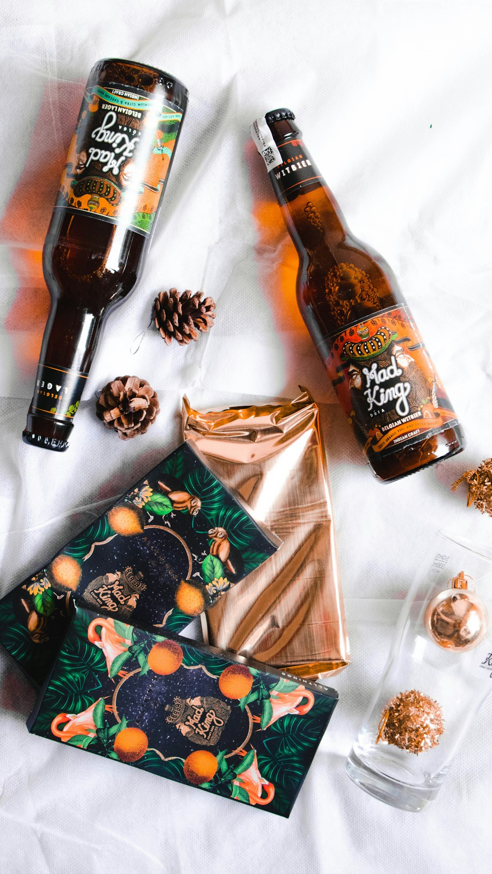 flat lay photography of Mad King beer on blanket