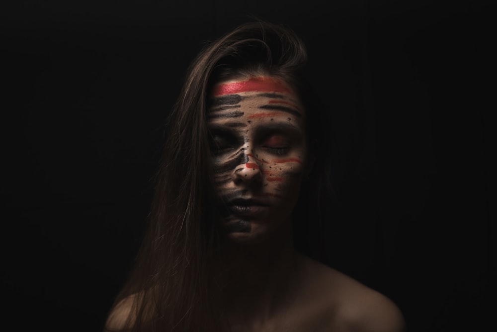 woman face with red and black face paint