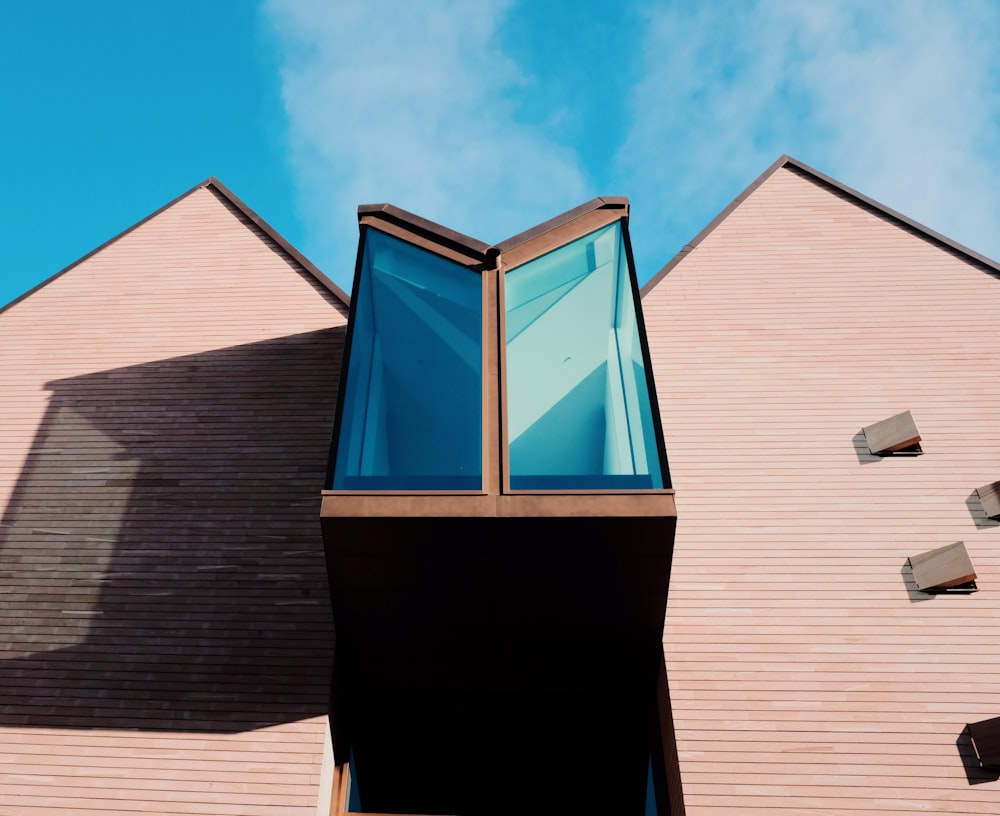 low angle photography of beige and blue building