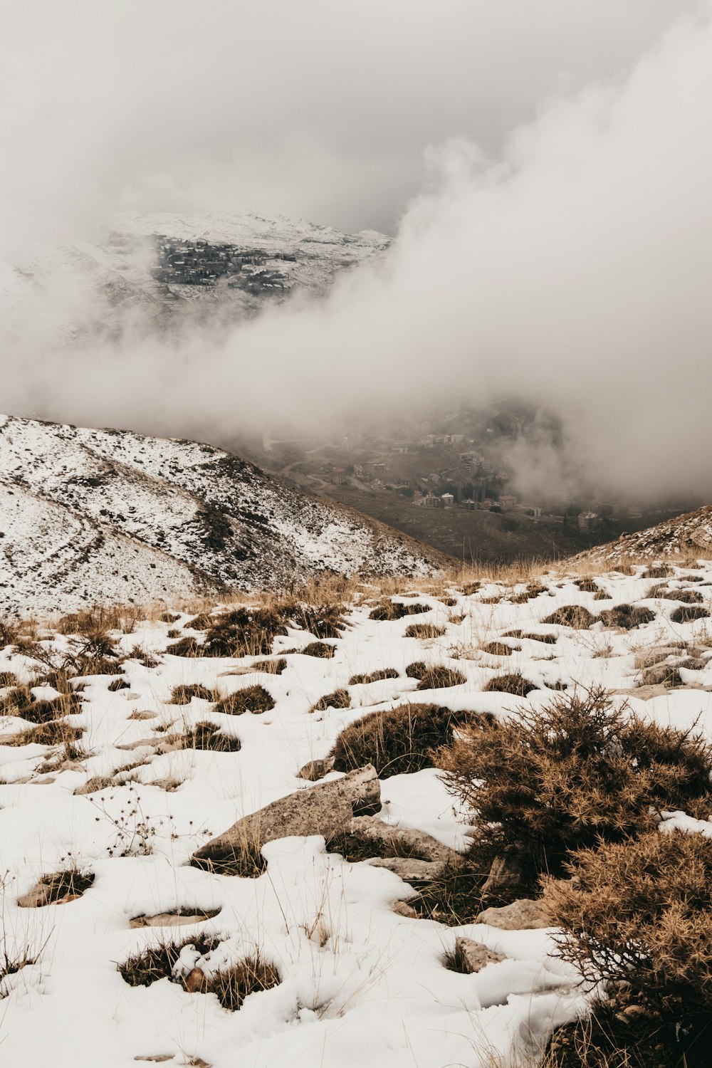 smoke near mountain covered with snow