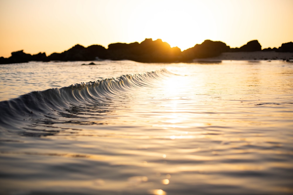 body of water during sunset