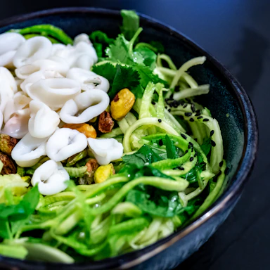 A colorful bowl of mixed seaweed salad featuring vibrant greens and textures.