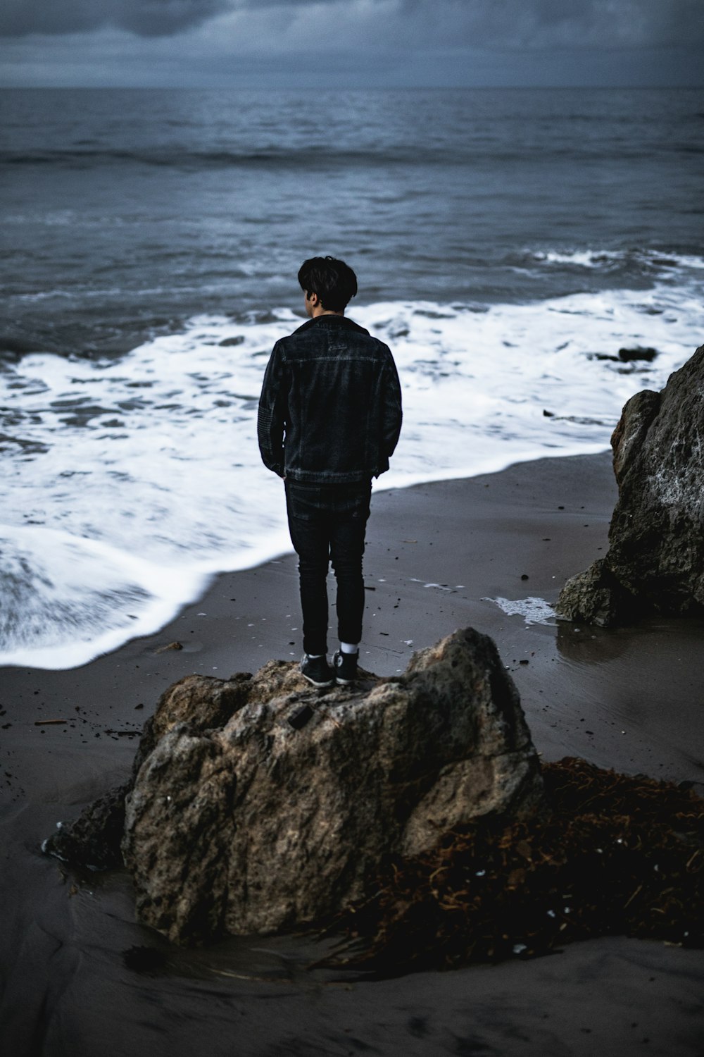 man standing in front of seashore