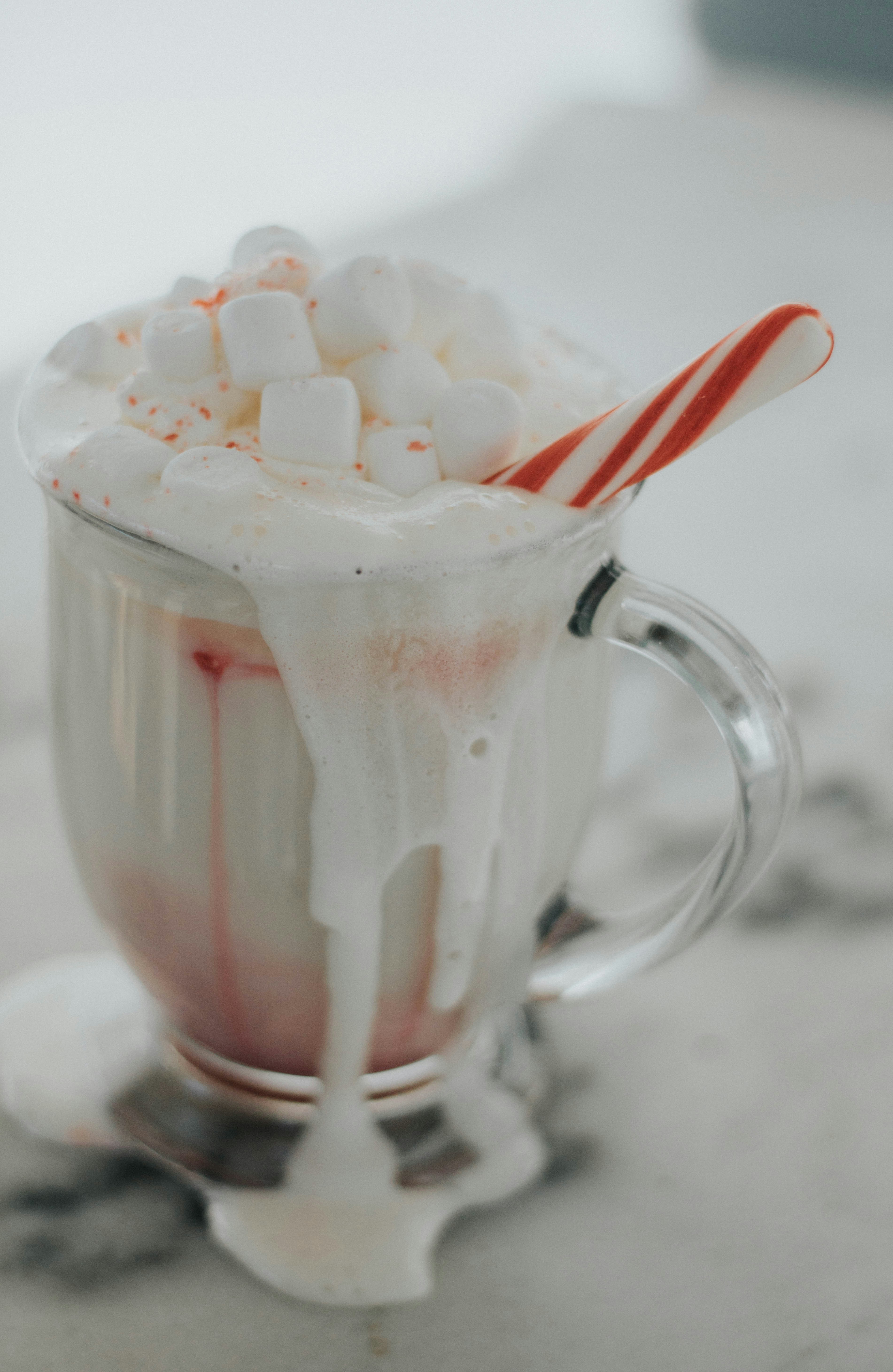 Glass jar filled with premium hot chocolate mix topped with marshmallows and candy cane