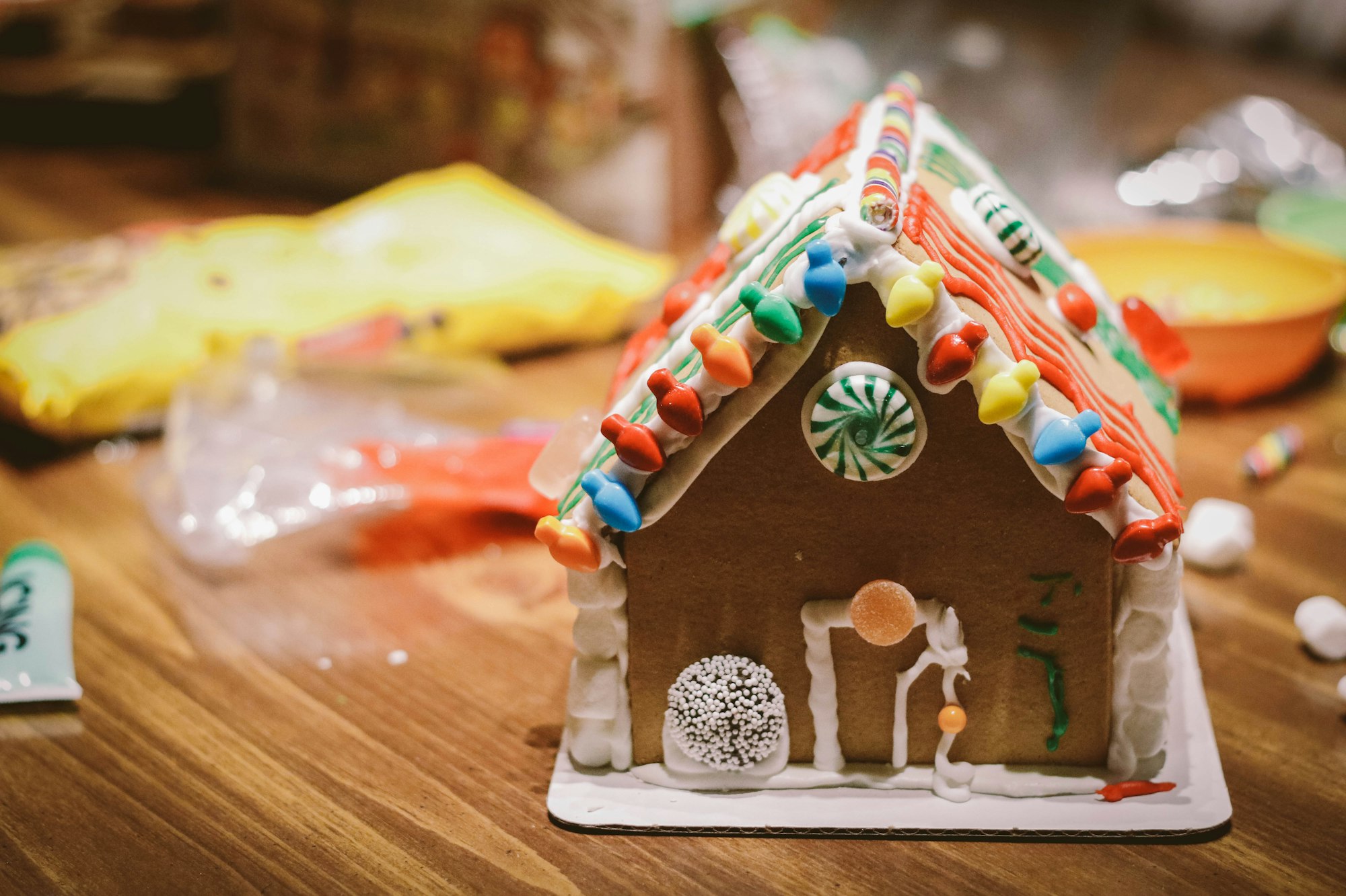 Gingerbread house with candy and other Christmas decorations.