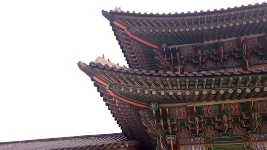 close-up photo of Asian architecture during daytime in Gwanghwamun Gate South Korea
