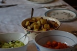 Elegant table setting featuring assorted homemade preserves and fresh vegetables