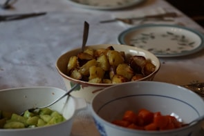 Elegant table setting featuring assorted homemade preserves and fresh vegetables