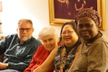 A diverse group smiling while sharing financial tips in a warm, modern living room.