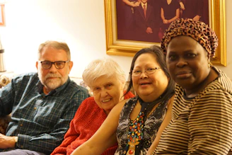 A family smiling together in a secure living room with visible IP security cameras.