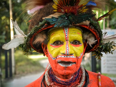 man wearing traditional dress equatorial guinea teams background