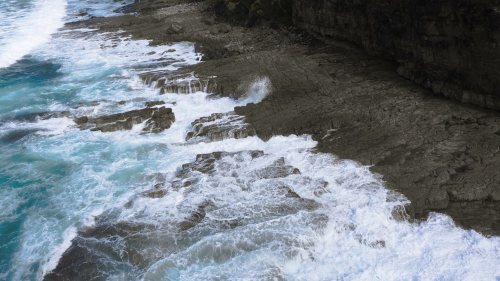 seashore rocks crashing on shore