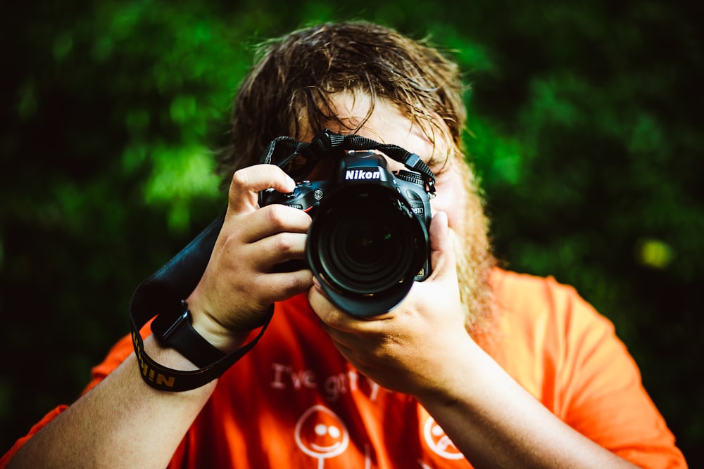 man holding Nikon camera