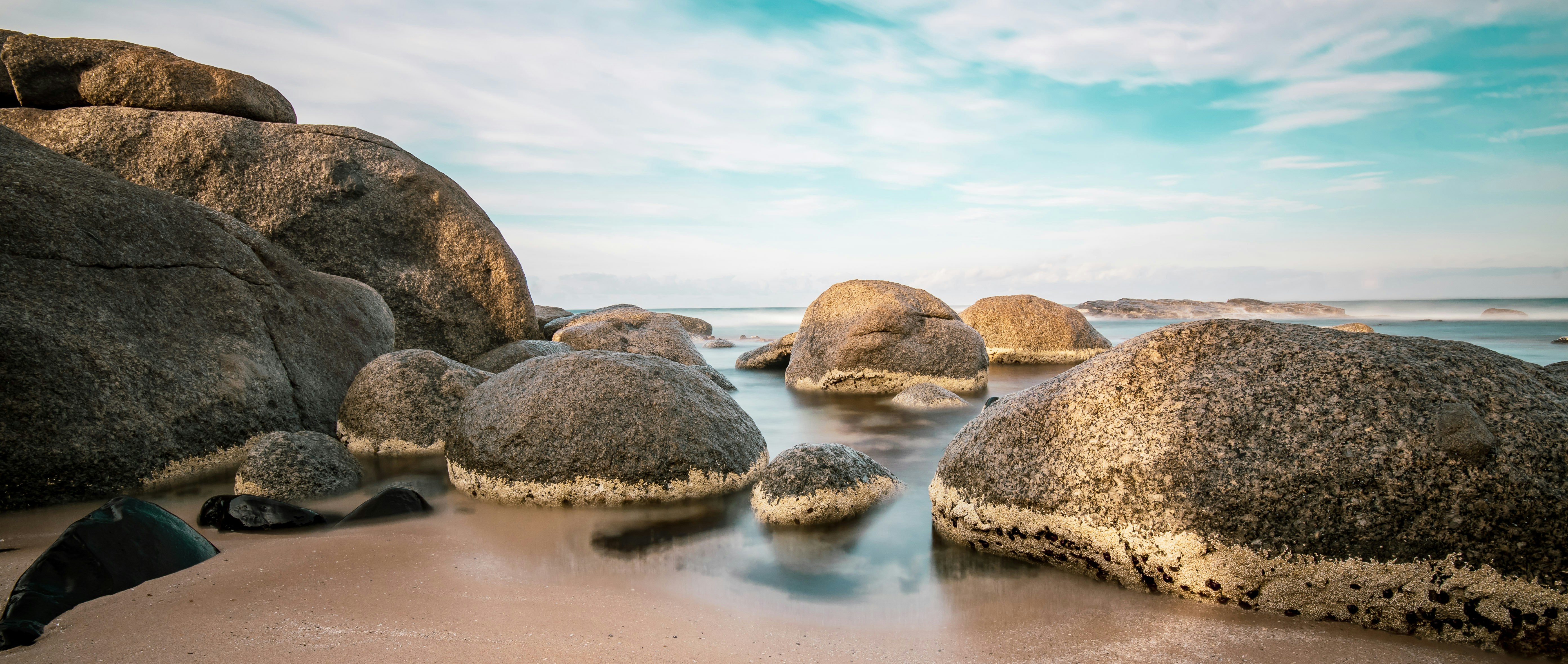 brown sea rocks during daytime