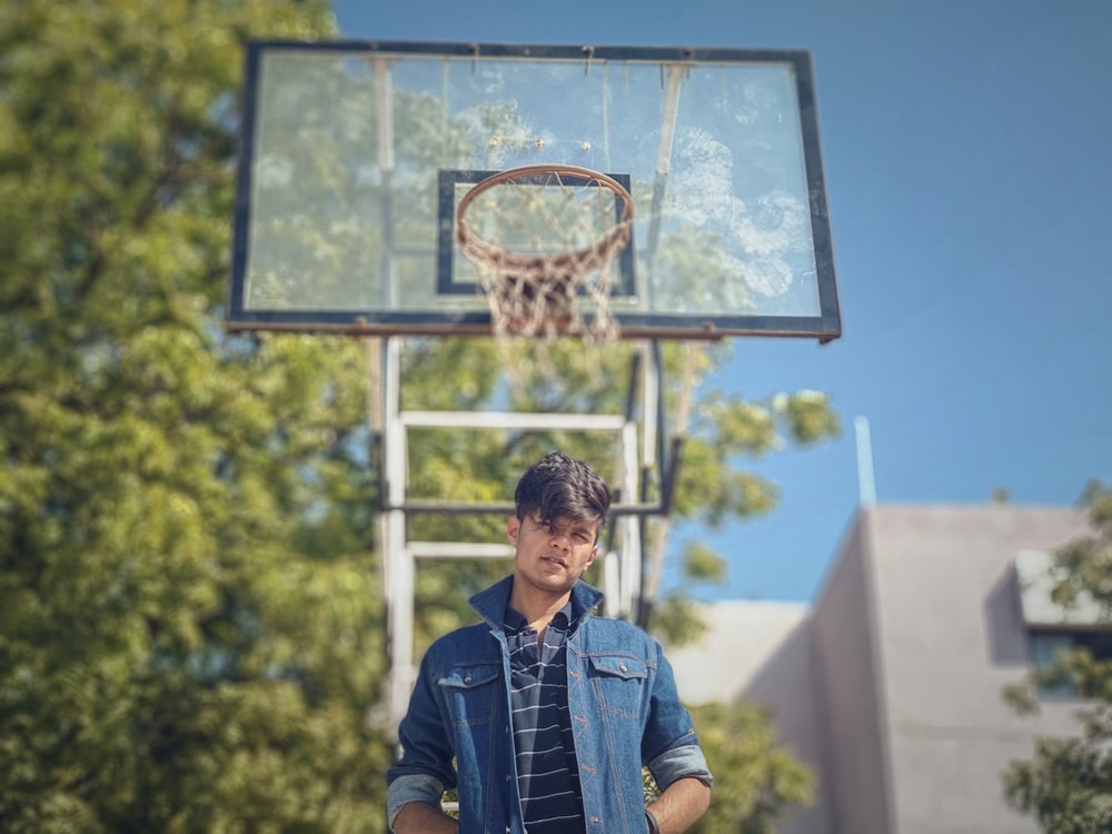 man standing near basketball system during daytime