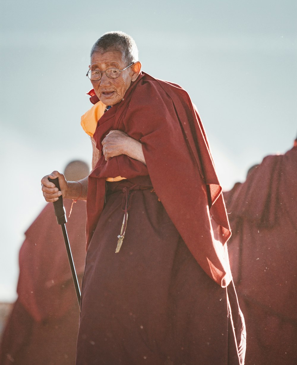 man standing while holding baton