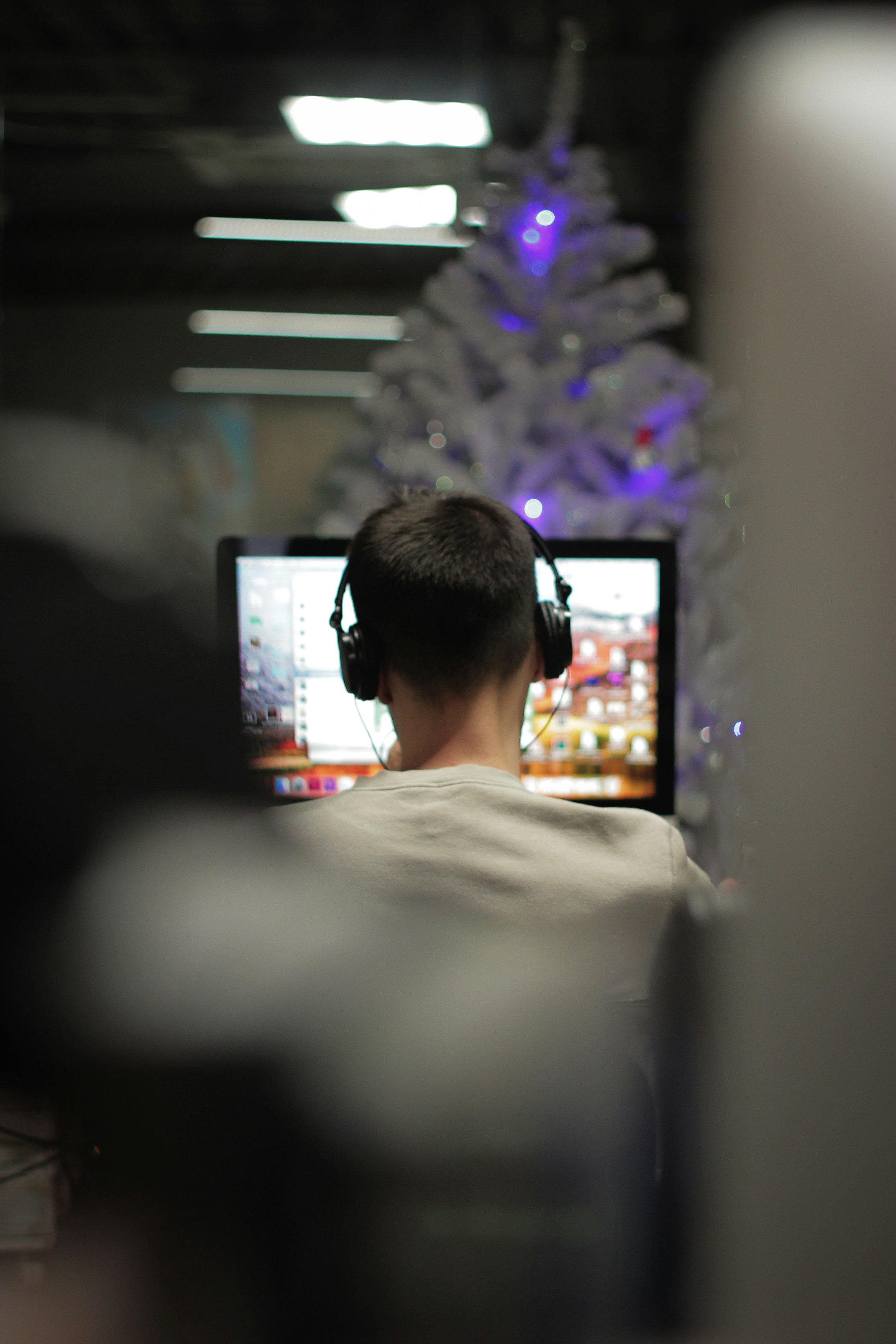 man using computer in selective focus photography