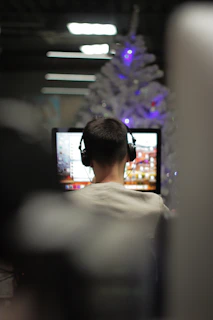man using computer in selective focus photography