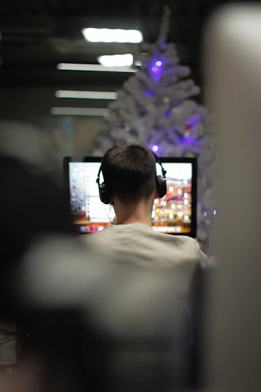 man using computer in selective focus photography