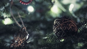 Close-up of rustic wooden ornaments hanging on a beautifully decorated Christmas tree