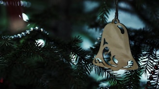 Hands crafting a delicate laser-cut wooden ornament with colorful 3D printed details.