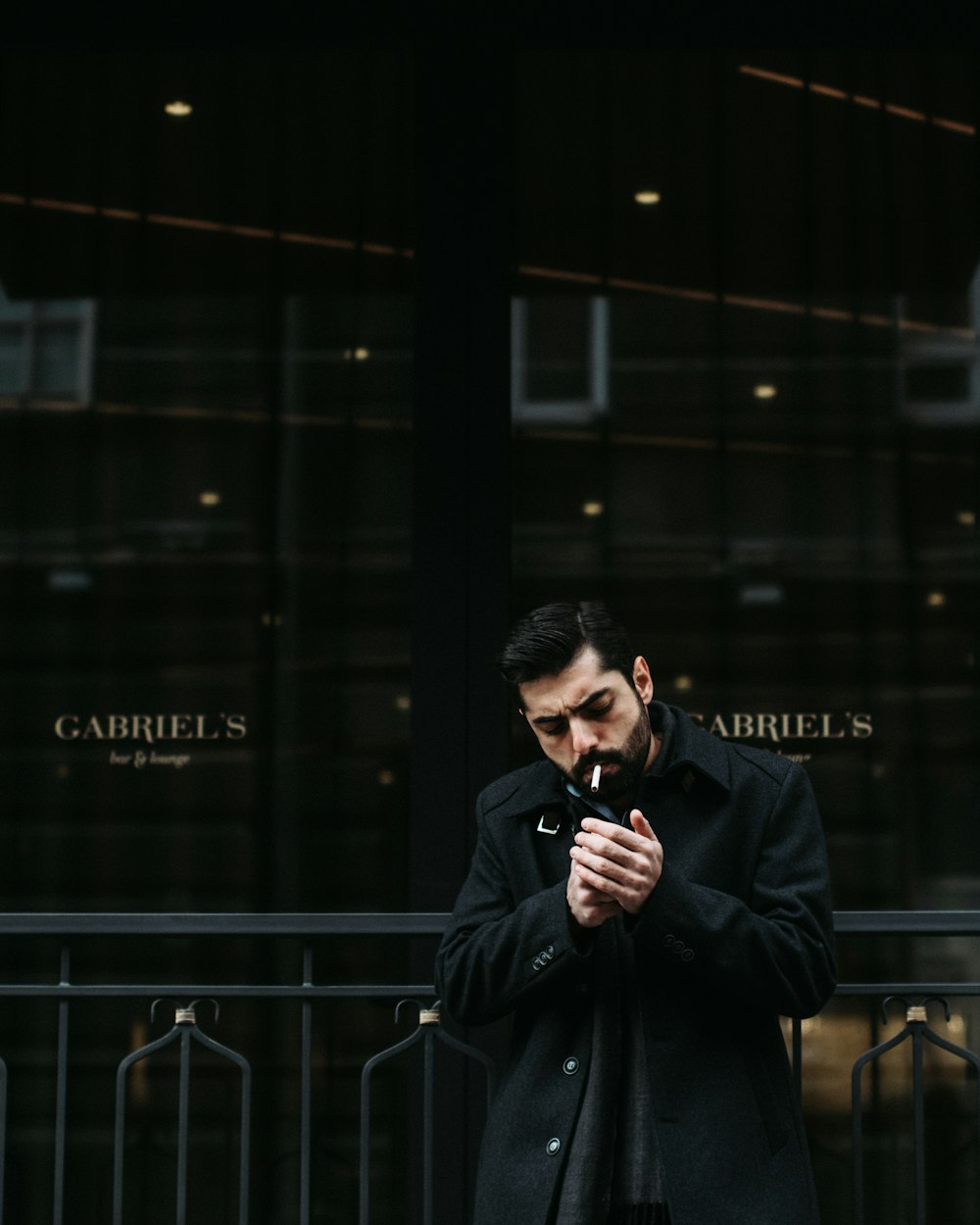 standing man smoking cigarette