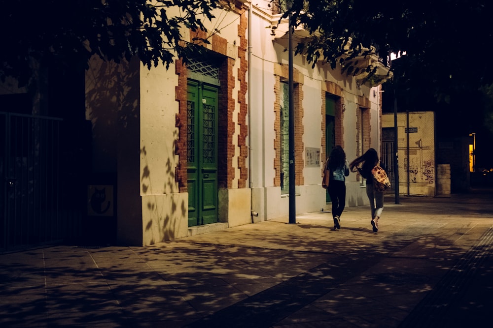 two girls walking on street