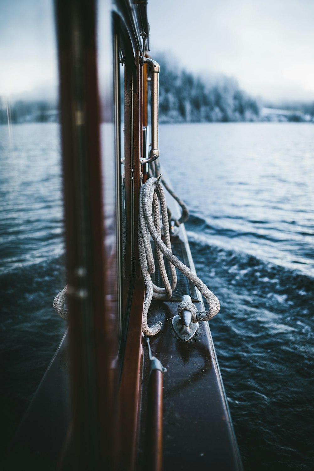 selective-focus photograph of rope beside body of water