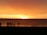 A group of happy travelers enjoying a beautiful beach sunset in Lombok.