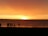 A group of friends enjoying a beach sunset, capturing joyful moments together.