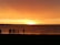 A group of friends enjoying a beach sunset, capturing joyful moments together.