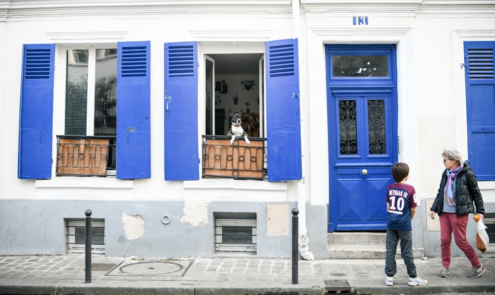 two persons standing beside closed door