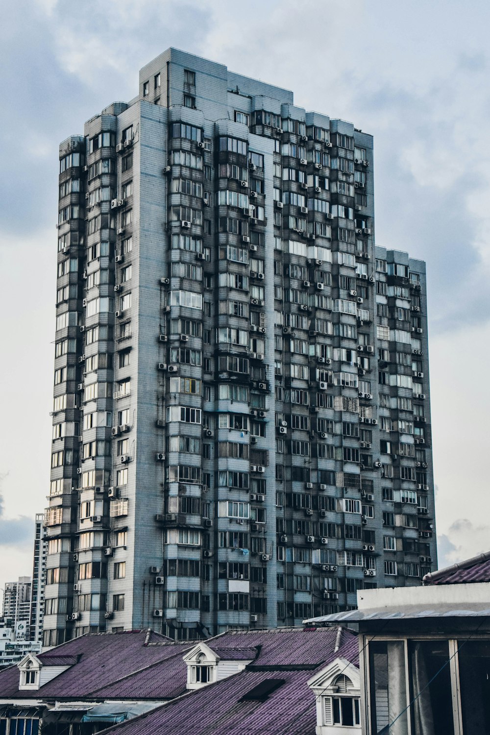 curtain wall building beside house at daytime