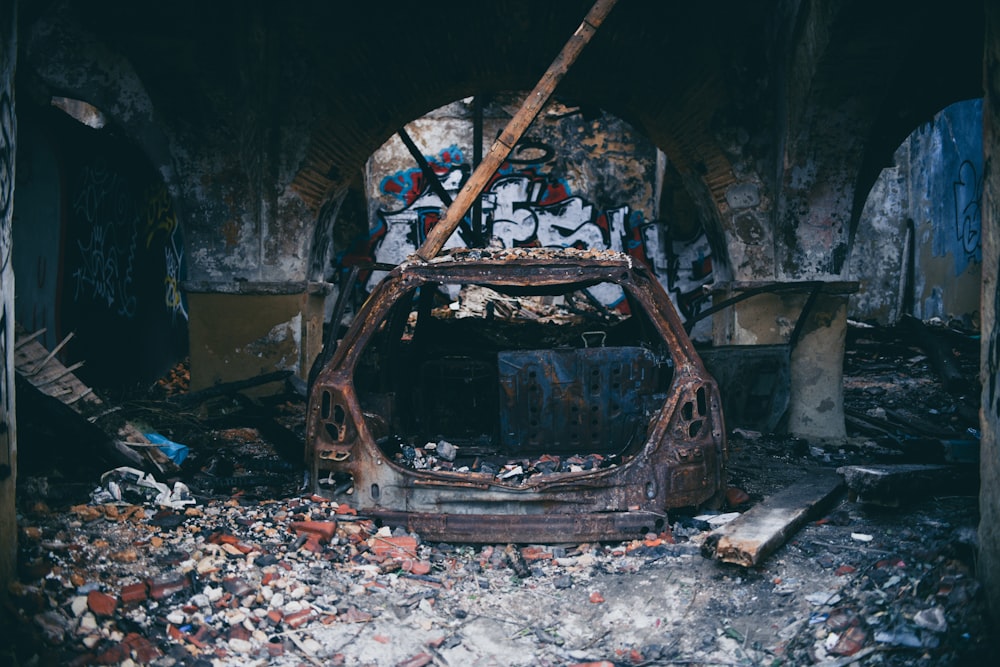 wrecked vehicle inside abandoned building