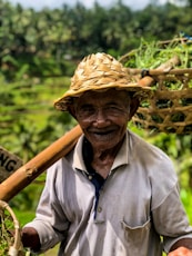 man in grey polo shirt carrying baskets