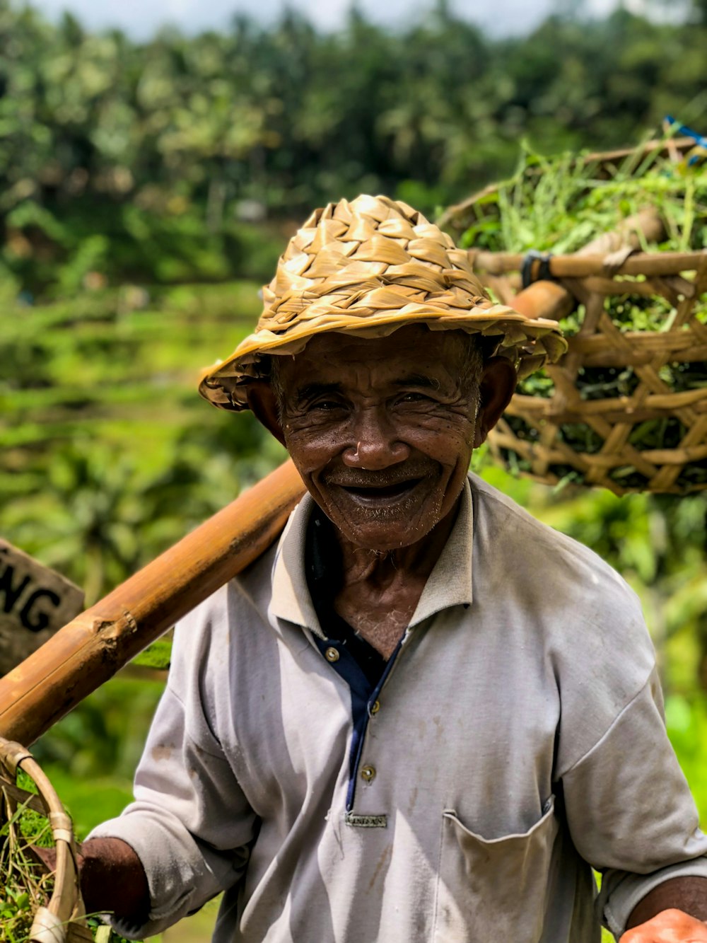 man in grey polo shirt carrying baskets