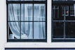 Elegant window dressed with layered curtains and blinds