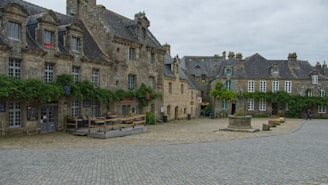 Quiet village square with ancient church and shaded benches.