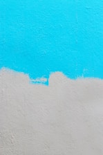 Freshly painted interior wall with cyan blue accents in a modern home.